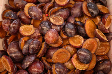 Frozen seedless plums in the store.