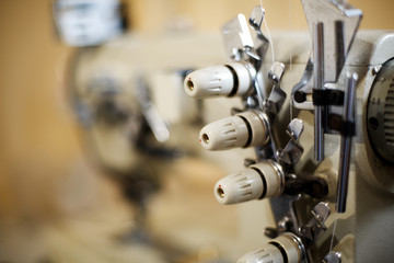 closeup details on sewing machine overlock. Workplace seamstress.Tailoring industry