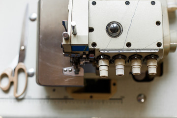 top view closeup details on sewing machine overlock. Workplace seamstress.Tailoring industry
