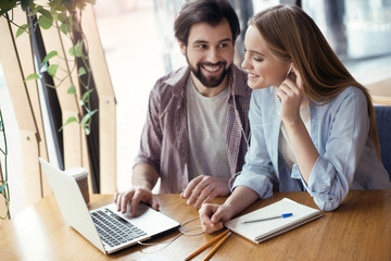 Young people coworking together at creative office sitting liste