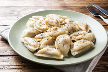Dumplings, filled with meat, ravioli. Traditional Russian dish pelmeni. Dumplings with filling horizontal