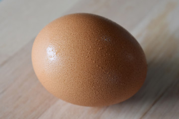 closeup of chicken egg on wooden background, texture of egg shell