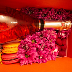gift composition with champagne, flowers and sweets