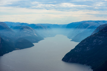 Fototapeta na wymiar Blue misty view on Lysefjord from Preikestolen trail, Norway