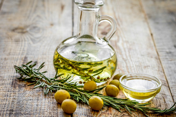 oil in carafe with spices and olive on wooden background mock-up