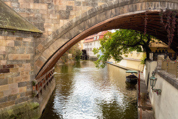 Czech Republic, Prague, Certovka river, Devil's Channel, also called Little Prague Venice between Kampa island and Mala strana in Czech Republic with Historic Mill Wheel and boat