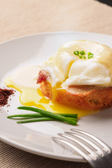 Breakfast is Eggs Benedict - toasted English muffins, bacon, ham, poached eggs, herbs and delicious buttery hollandaise sauce.