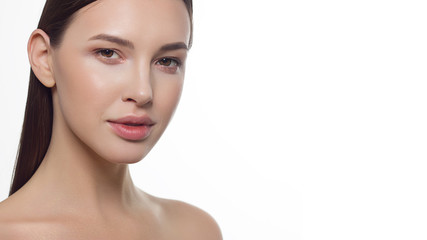 Fototapeta premium Closeup portrait of a woman with developing straight hair. Sweet tender young girl brunette. Natural lipstick, transparent clean skin. Skin care natural cosmetics in the spa salon or cosmetology.