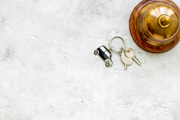 booking hotel room, ring and keys stone desk background top view
