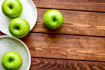 Healthy green food with apples on plates wooden background top v
