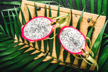 Dragon exotic fruit from Asia. Cutting flesh with seeds
