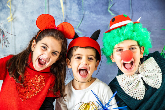 Three Kids Celebrating Carnival Or New Years Eve