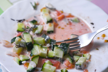 Man eats vegetable salad with a fork.