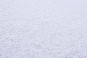 Texture of fresh snow covering ground thickly on frosty winter morning outside.