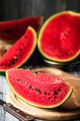 Watermelon on a rustic table. Pieces of red flesh close up