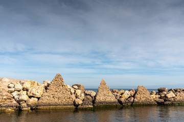 Breakwater pyramidal constructions at the mouth of a river to the sea.