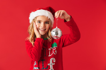 Cheerful little girl wearing Christmas costume