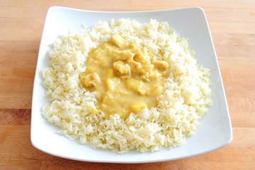 chicken curry  with rice, on square plate