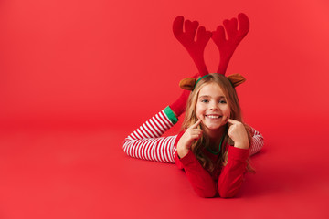 Cheerful little girl wearing Christmas raindeer costume