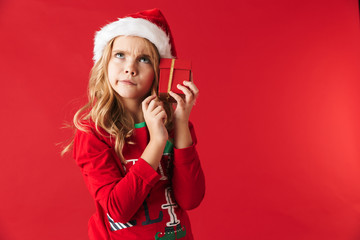 Pensive little girl wearing Christmas costume