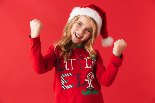 Cheerful little girl wearing Christmas costume