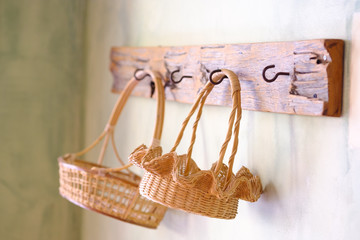 Rattan wicker baskets hanged on old wood at the beautyful wall.