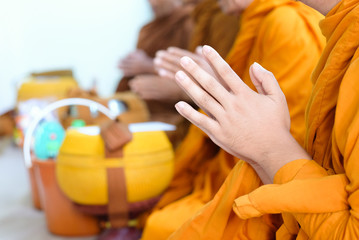 Hands of Buddhist monk praying to blessed people at  New House ceremony, Thailand.