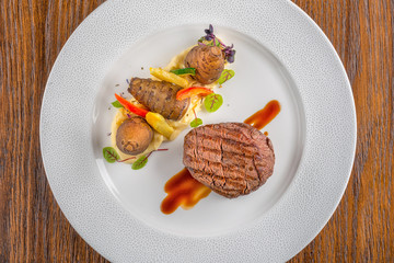 delicious beef steak with sauce and vegetable, served on white plate, modern gastronomy, michelin restaurant