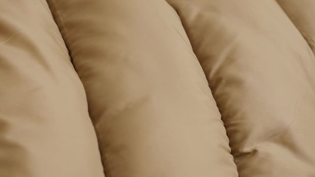 Slow tilt over puffer jacket fabric 4K footage