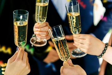 Celebration. Hands holding the glasses of champagne and wine making a toast. The party, celebration, alcohol, lifestyle, friendship, holiday, christmas, new, year and clinking concept