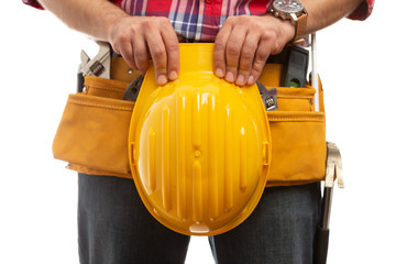 Builder holding hardhad over tool belt.