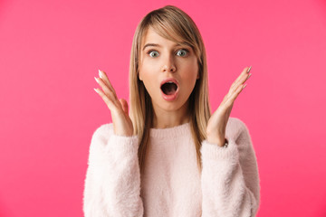 Excited young blonde woman wearing sweater