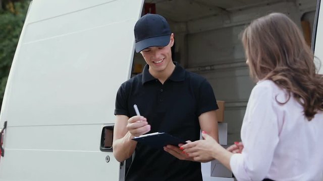 Delivery Courier Service. Man Delivering Package To Woman
