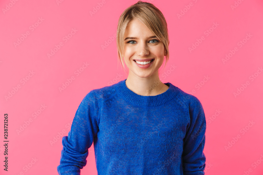 Wall mural Cheerful young blonde woman wearing sweater