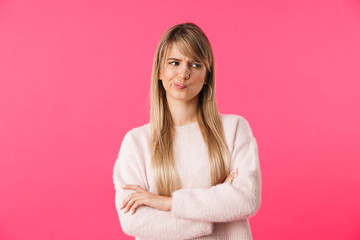 Upset young blonde woman wearing sweater
