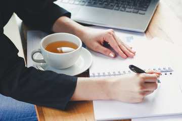 Young woman sit working in a coffee shop,Employees are working outside the company,Students are searching for reports at the restaurant,The girl is shopping online.