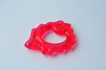 Teether for babies teeth in the form of a pink hedgehog with a cooling effect on a white background