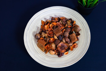 Potpourri Close-up view in the wooden plate with dark background