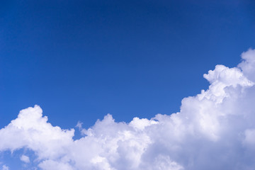 Naklejka na ściany i meble white fluffy cloud on bright blue sky with copy space on sky