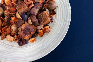 Potpourri Close-up view in the wooden plate with dark background
