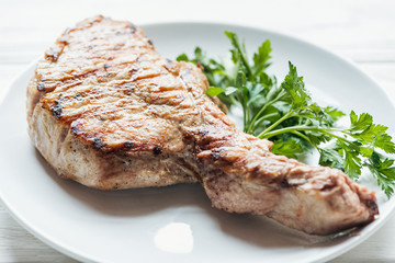 selective focus of delicious rib eye meat steak on plate with parsley