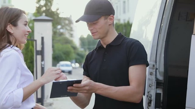 Delivery Courier Service. Man Delivering Package To Woman