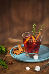 Cold ginger tea with orange and lemon in glass cups. Tea with sugar. The decor. Cinnamon and Rosemary Spices