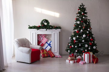 Christmas tree with lights garlands adorned with new year holiday gifts
