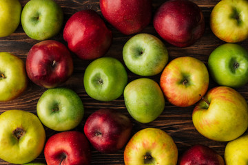 top view of ripe multicolored apples on wooden table