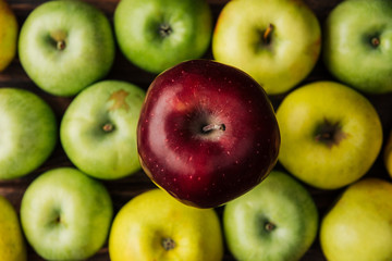 top view of tasty red delicious apple with multicolored fruit at background