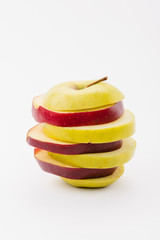 fresh sliced red and golden delicious apples on white background