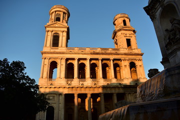 Fototapeta premium Eglise Saint Sulpice. Paris, France. Neoclassical facade with sunset light. Blue sky.