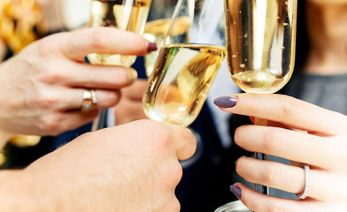 Celebration. Hands holding the glasses of champagne and wine making a toast. The party, alcohol, lifestyle, friendship, holiday, christmas, new, year and clinking concept