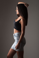 Silhouette of young woman in fit jean skirt